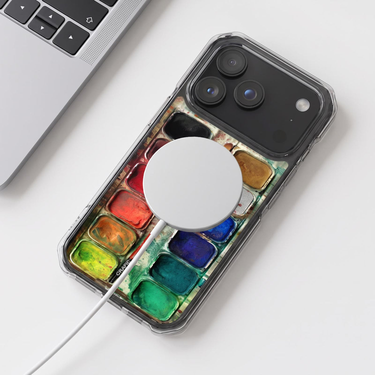 The watercolor case in MagSafe with a charger attached