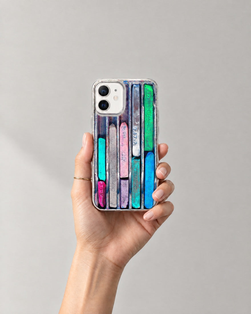 A hand holding the Pastels case