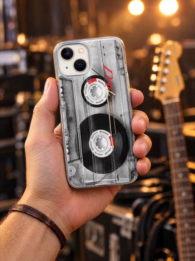 The guitarist holding the Cassette Tape case